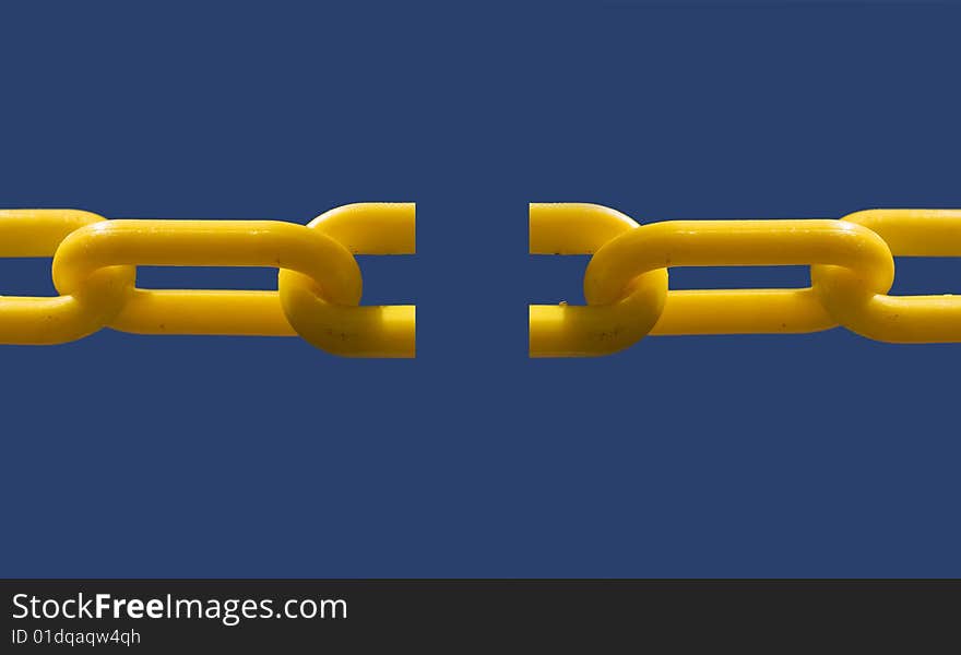 Close up of broken chain link set against blue sky background for copy text