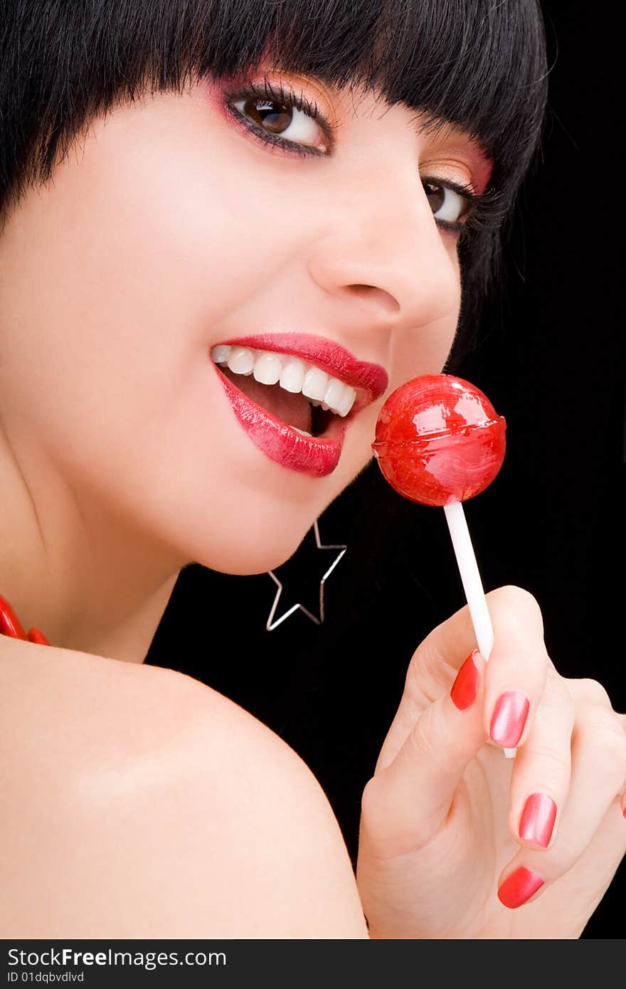 Sweet woman with candy on black background