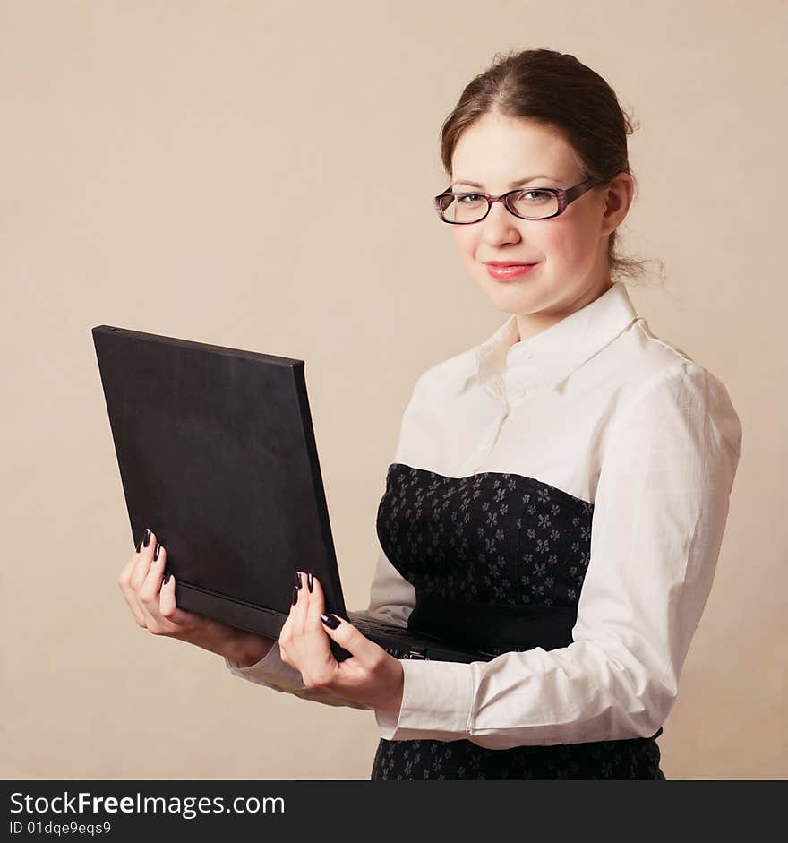 Young business woman holding a laptop. Young business woman holding a laptop