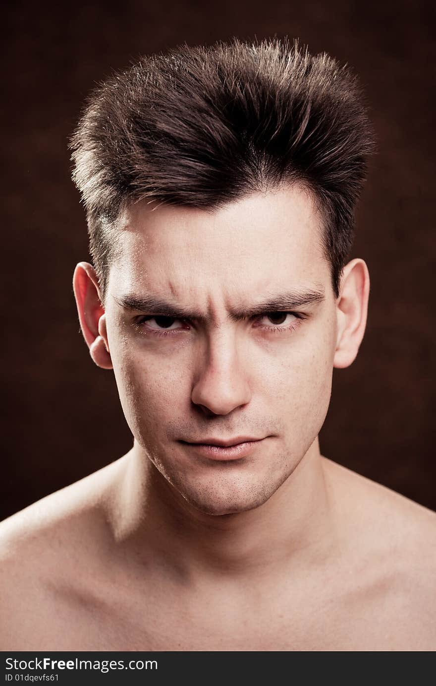 Young man facial expression on dark background