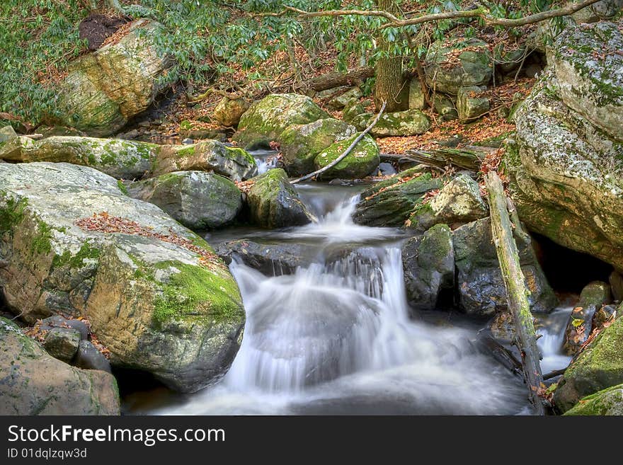 Beautiful waterfall in the middle of the forest during autumn. Beautiful waterfall in the middle of the forest during autumn.