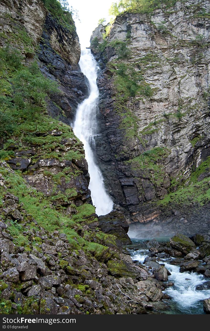 Stalheimfossen waterfall in the beautiful Naeroydalen is situated in a narrow valley with small birch trees. Stalheimfossen waterfall in the beautiful Naeroydalen is situated in a narrow valley with small birch trees.