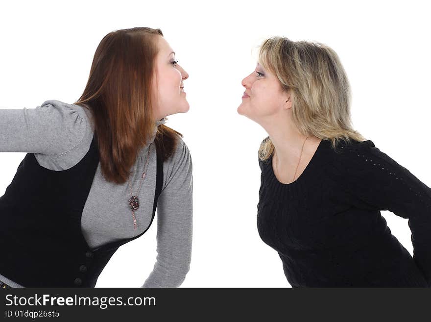 Two women look against each other and smile