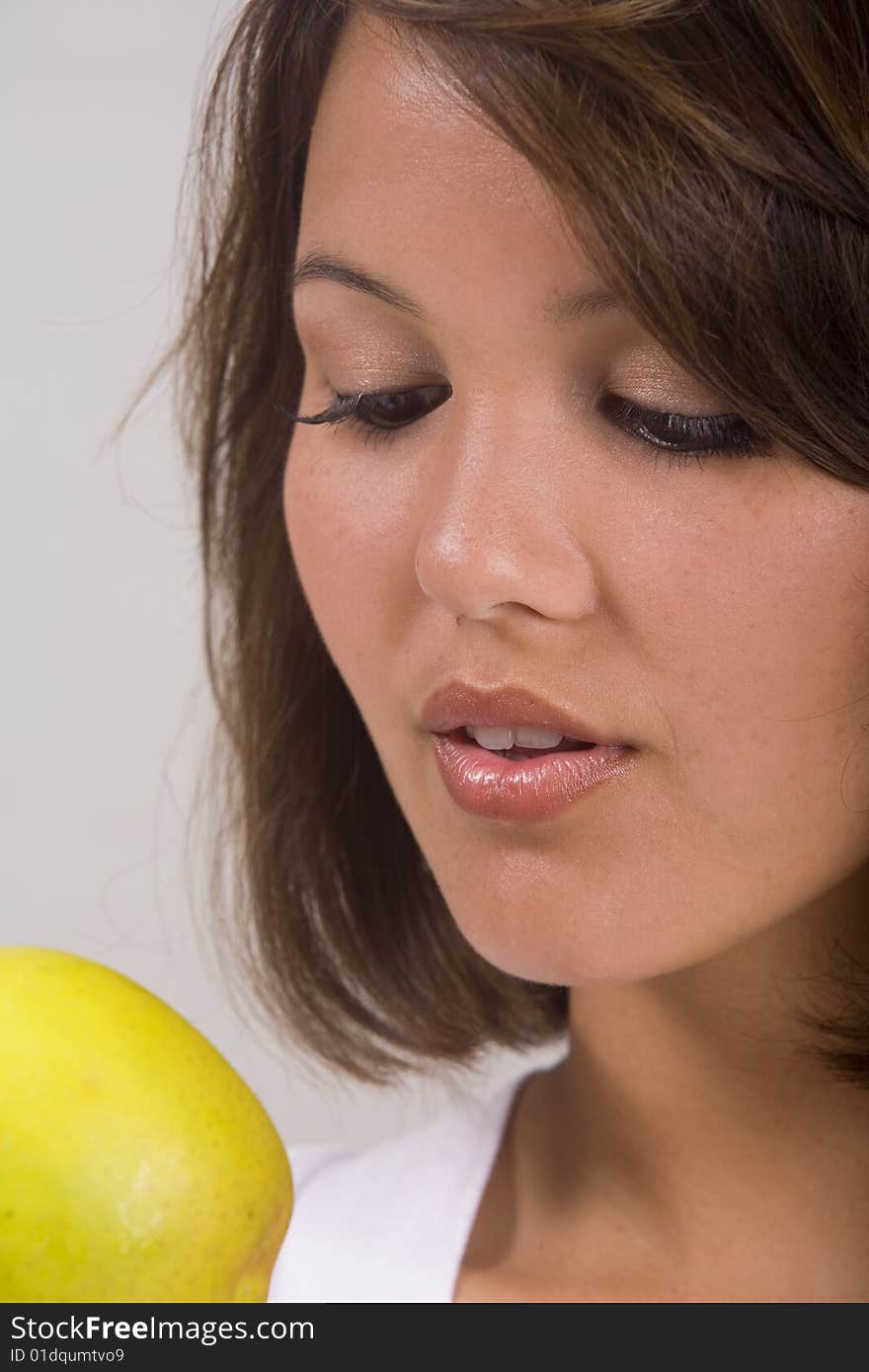 Asian-American girl eats an apple