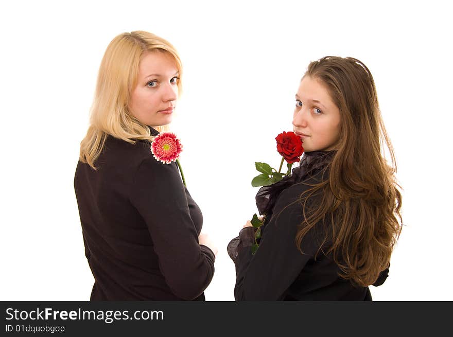 Portrait of two young women in black clothes with flowers on white. Portrait of two young women in black clothes with flowers on white