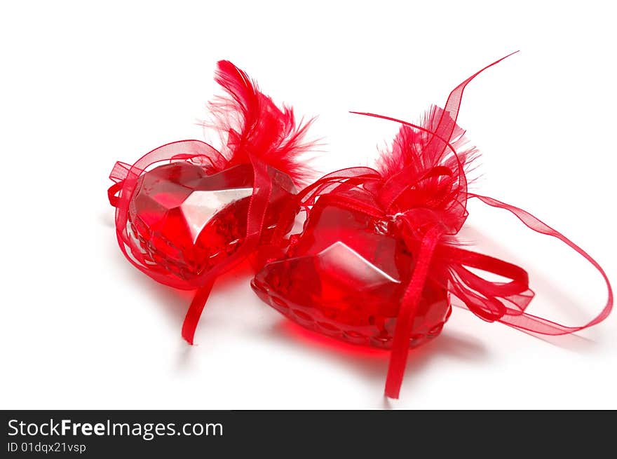 Two red glass hearts with plumage