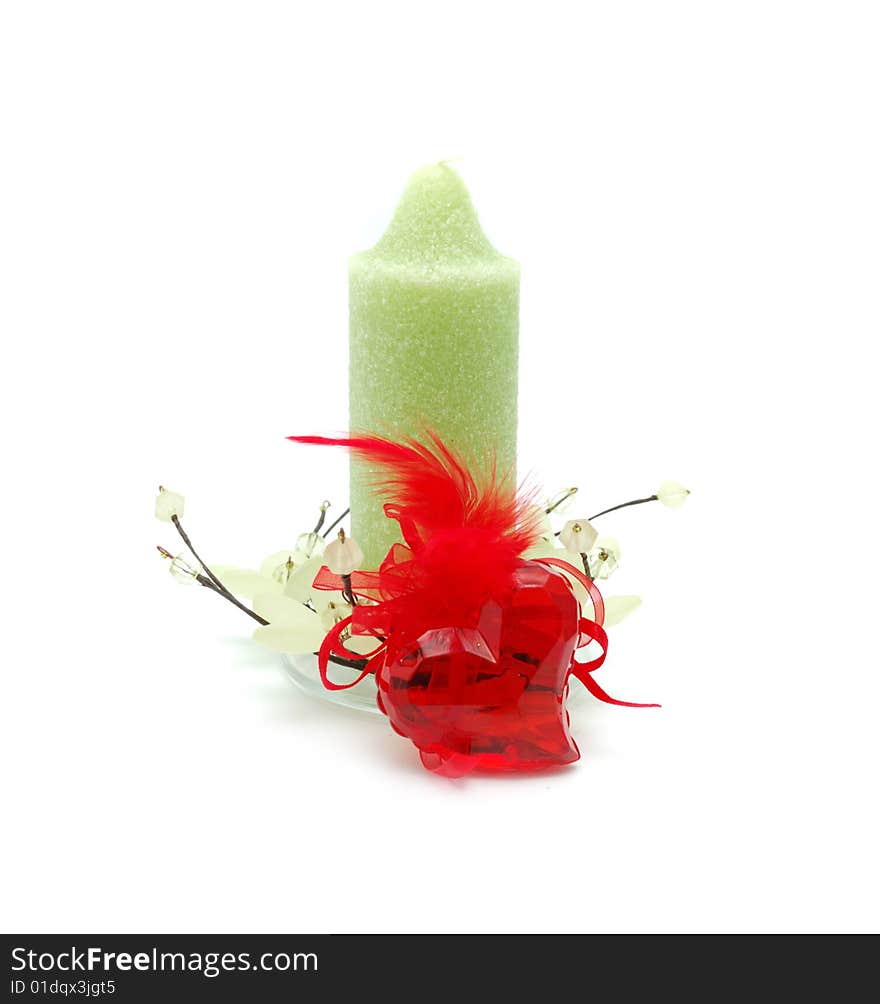 Red glass heart anf green candle. Red glass heart anf green candle