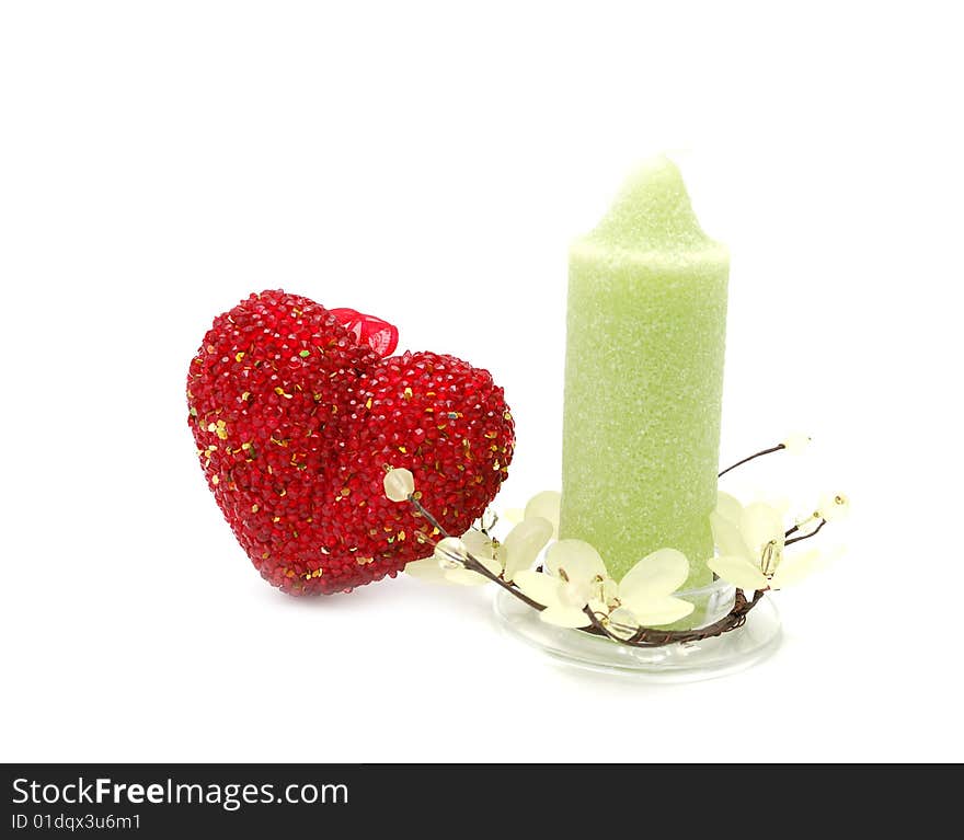 Red glass heart anf green candle. Red glass heart anf green candle