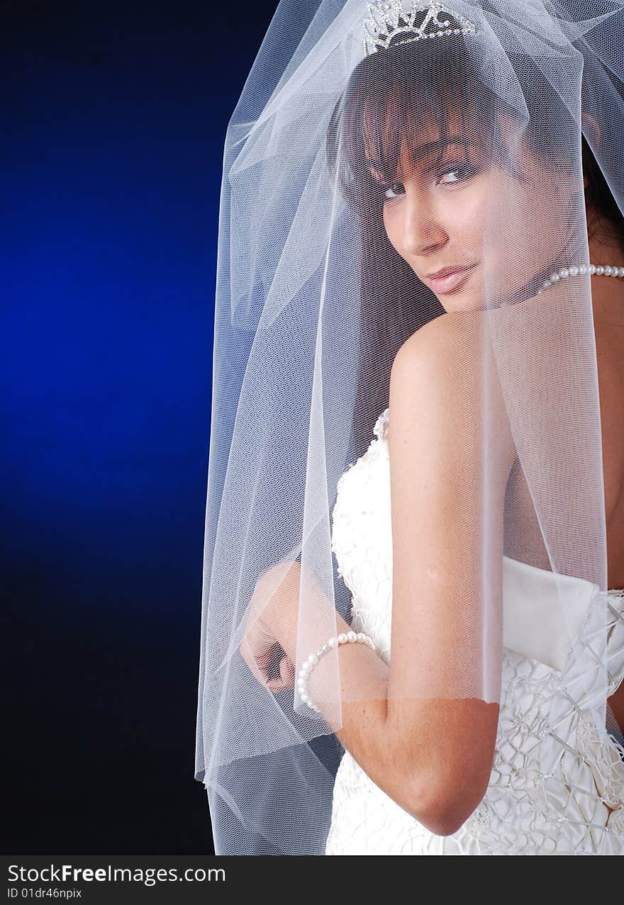 Portrait of young dark-hair bride on a black background. Portrait of young dark-hair bride on a black background