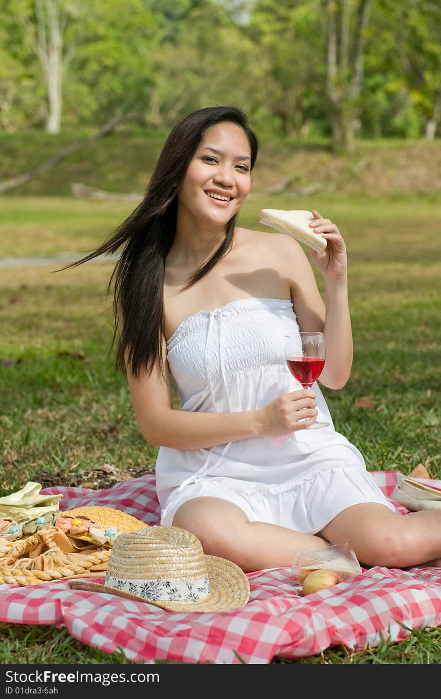 Woman eating a sandwich and drinking wine. Woman eating a sandwich and drinking wine