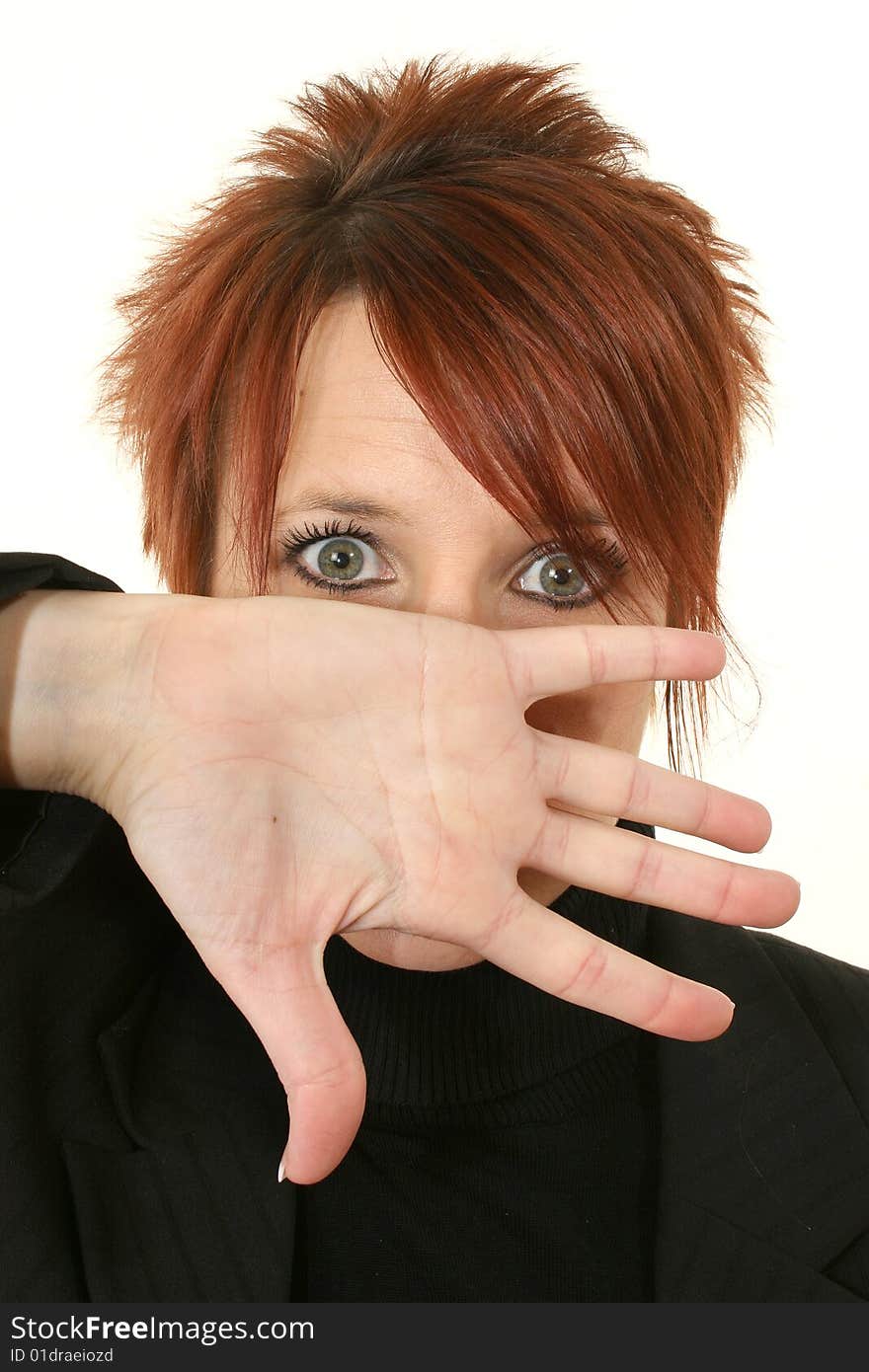 Young woman with bright red hair and hand near mouth shouting. Young woman with bright red hair and hand near mouth shouting.