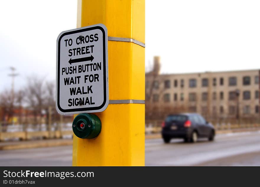 Button and sign at a traffic crosswalk. Button and sign at a traffic crosswalk.