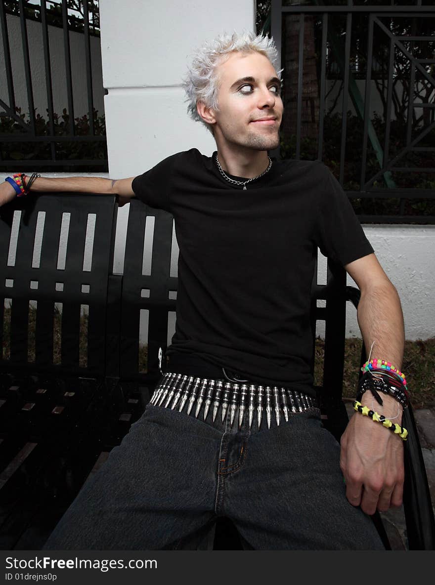 Young man sitting on a park bench. Young man sitting on a park bench