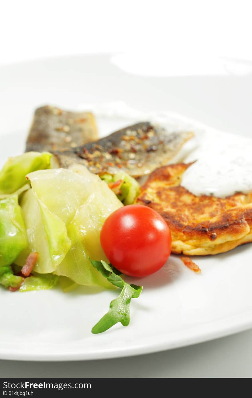 Cherry Tomato and Smoked Fish Fillet with Cabbage Salad and Thick Pancake. Isolated on White Background. Cherry Tomato and Smoked Fish Fillet with Cabbage Salad and Thick Pancake. Isolated on White Background