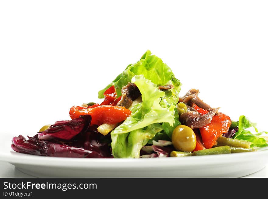 Salad with Anchovy, Olive and Vegetable Leaf. Isolated on White Background