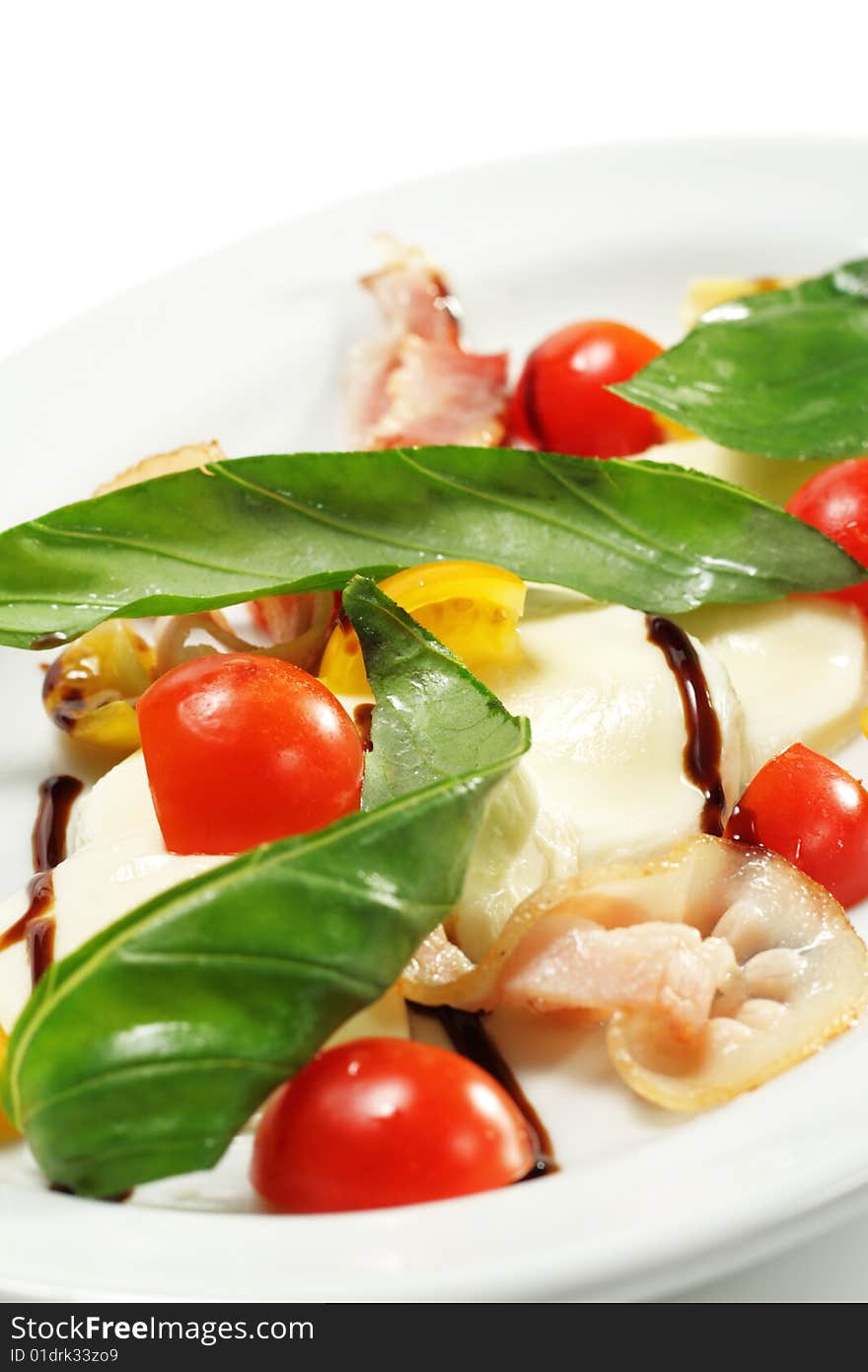 Salad with Cherry Tomato, Buffalo Cheese, Bacon and Vegetable Leaf. Isolated on White Background. Salad with Cherry Tomato, Buffalo Cheese, Bacon and Vegetable Leaf. Isolated on White Background