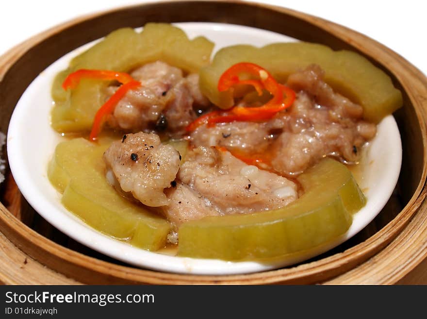 Chicken wih balsam pear puts in bamboo tray. Chicken wih balsam pear puts in bamboo tray.