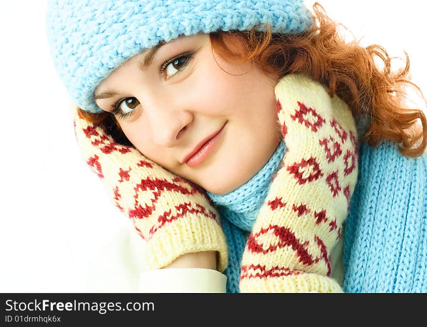 Beautiful ginger girl wearing a warm blue hat, scarf and mittens. Beautiful ginger girl wearing a warm blue hat, scarf and mittens