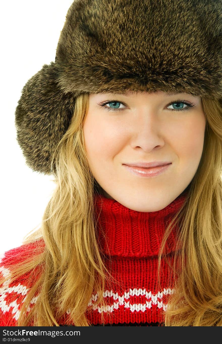 Portrait of a beautiful blond woman wearing a fur hat and warm red sweater. Portrait of a beautiful blond woman wearing a fur hat and warm red sweater