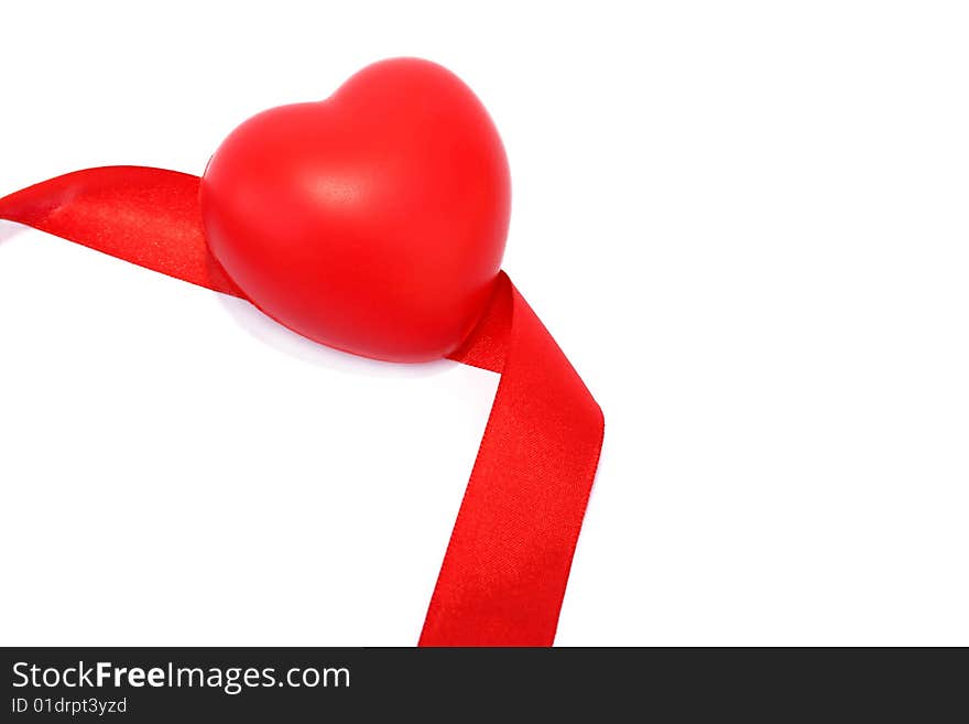 Red valentine heart and ribbon on white background.