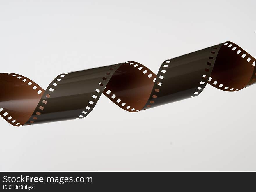 Strip of 35mm film coiled into a spiral on white background. Strip of 35mm film coiled into a spiral on white background