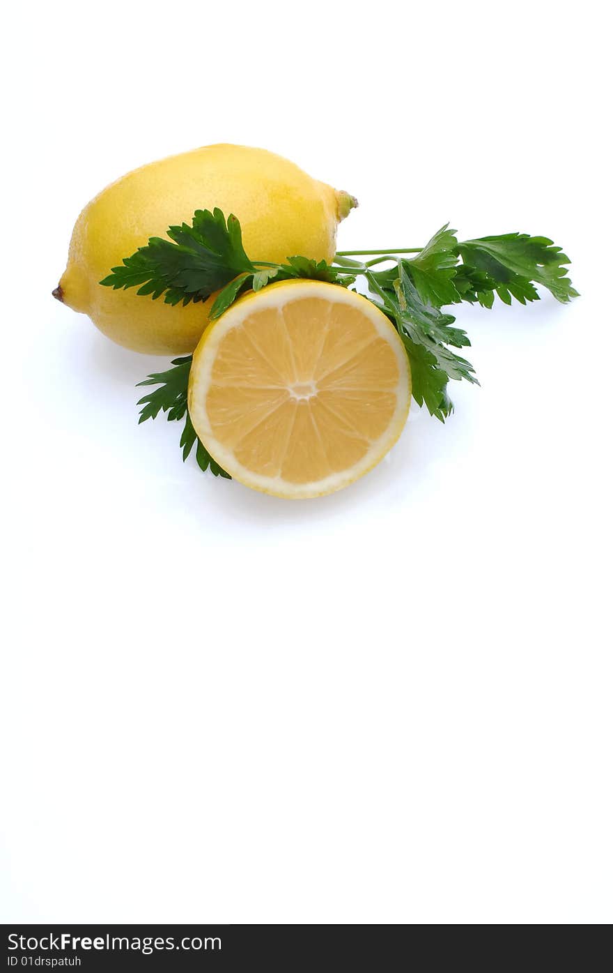 Lemon and parsley isolated at white