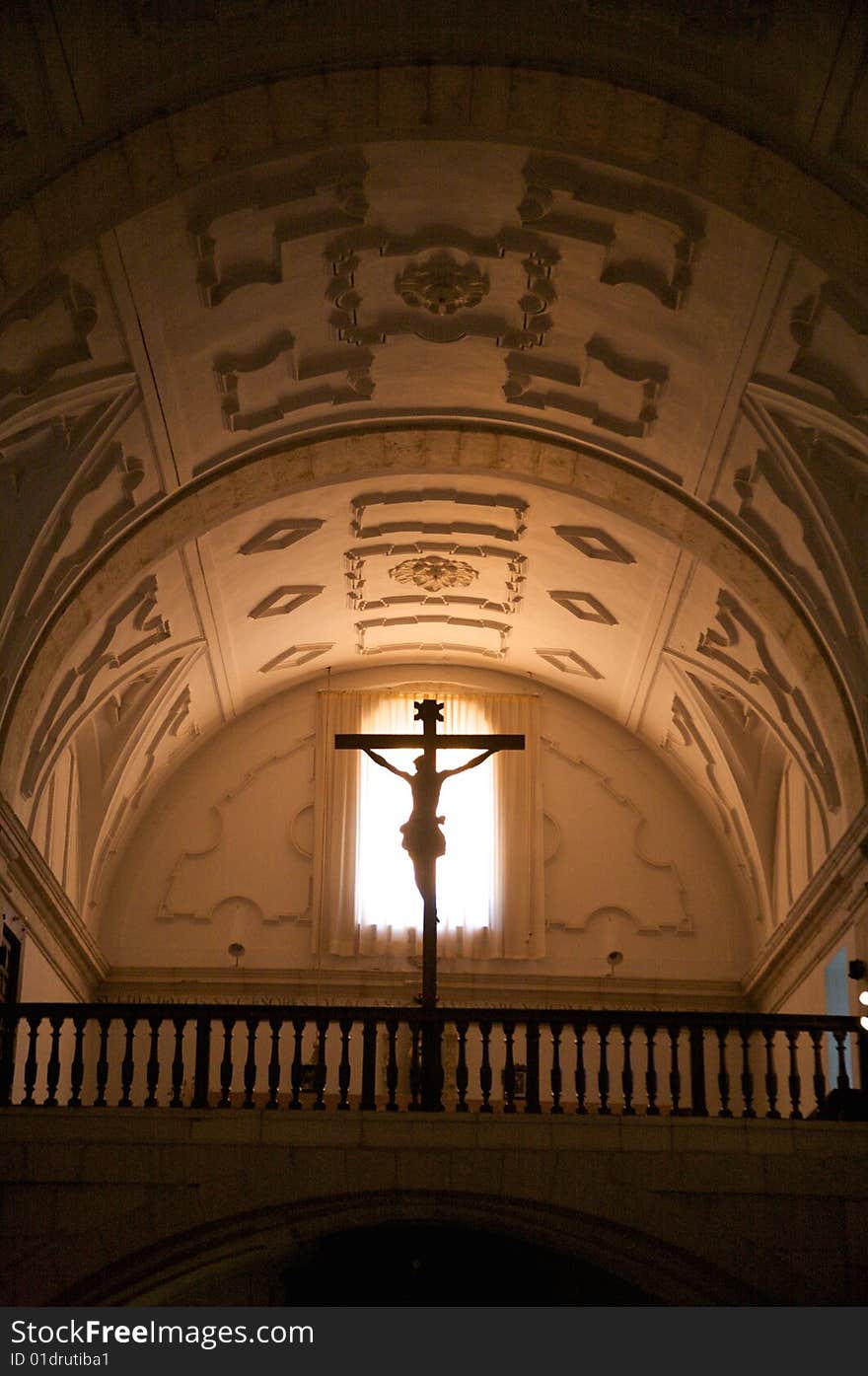 Cross against the light inside church of segovia spain