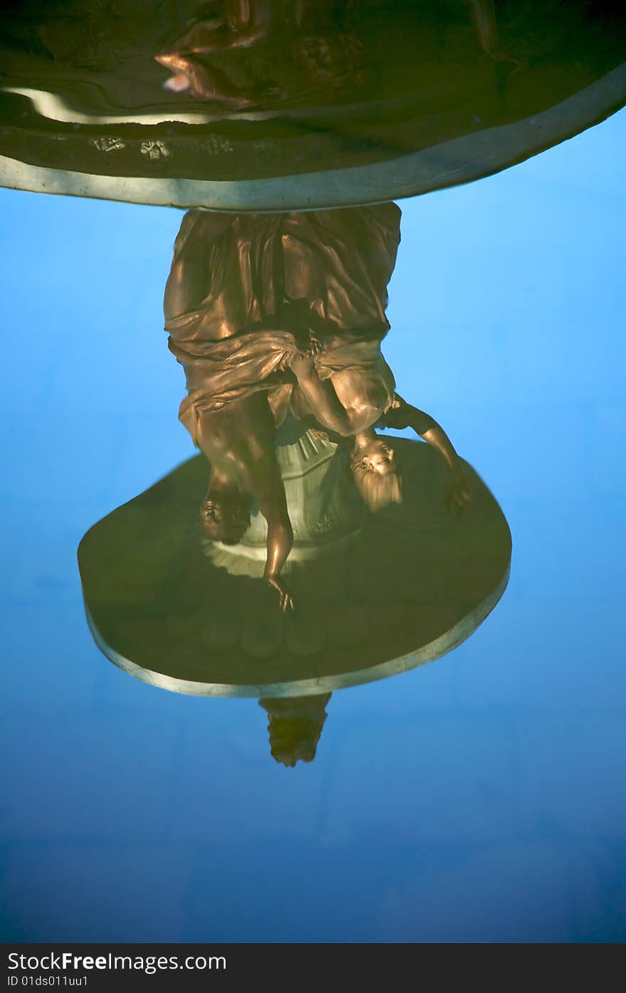 Statues reflected on water