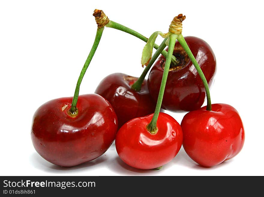 An image of five cherries over white