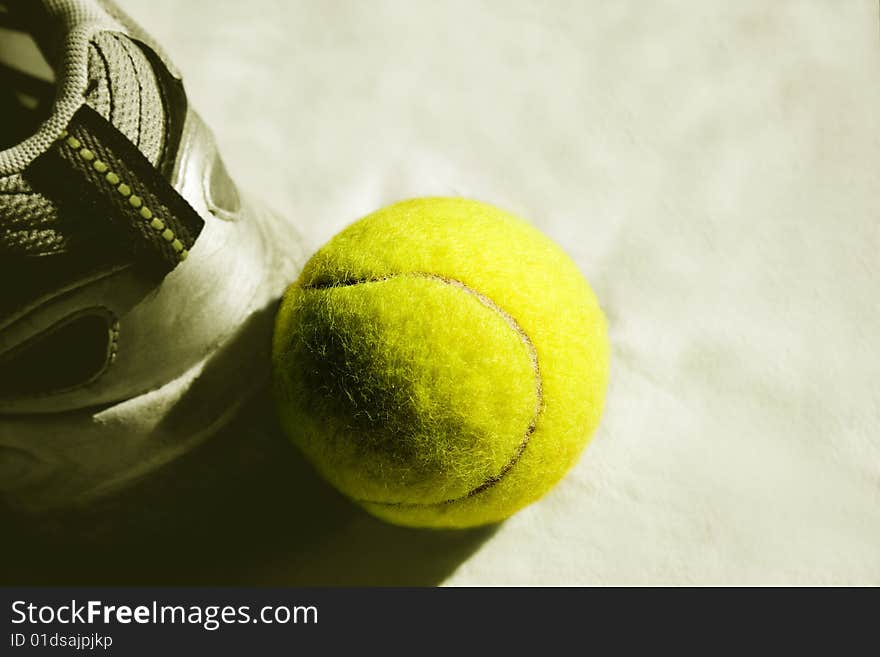 Yellow tennis ball with sneakers. Yellow tennis ball with sneakers