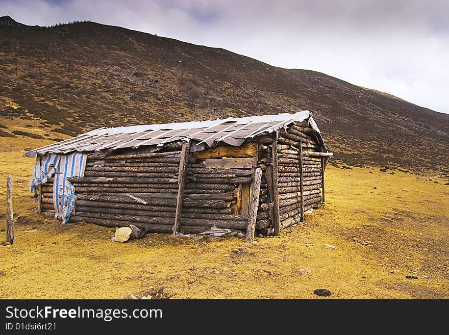 A log cabin of top of hill