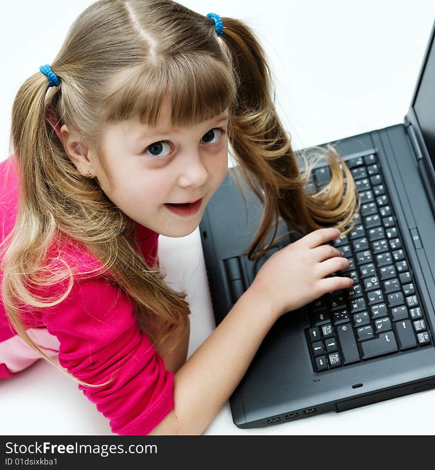 Stock photo: an image of a nice little girl with black laptop. Stock photo: an image of a nice little girl with black laptop