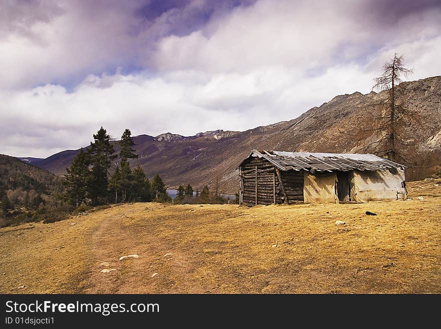 A log cabin of top of hill