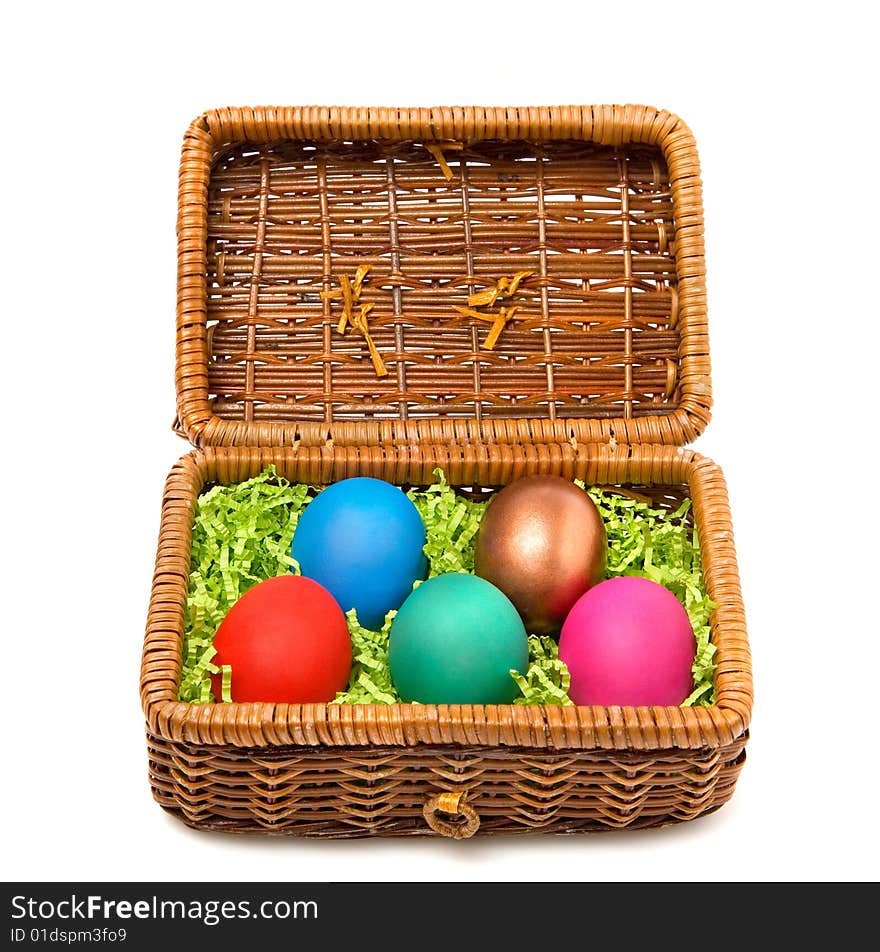 Five coloured Easter eggs in a rectangular straw casket. Five coloured Easter eggs in a rectangular straw casket