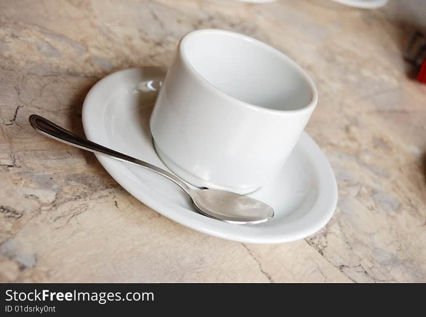 Empty white tea or coffee cup and spoon. Empty white tea or coffee cup and spoon