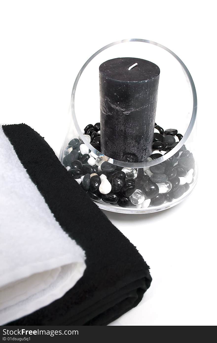 Towels and candle inside a glass vase. Towels and candle inside a glass vase