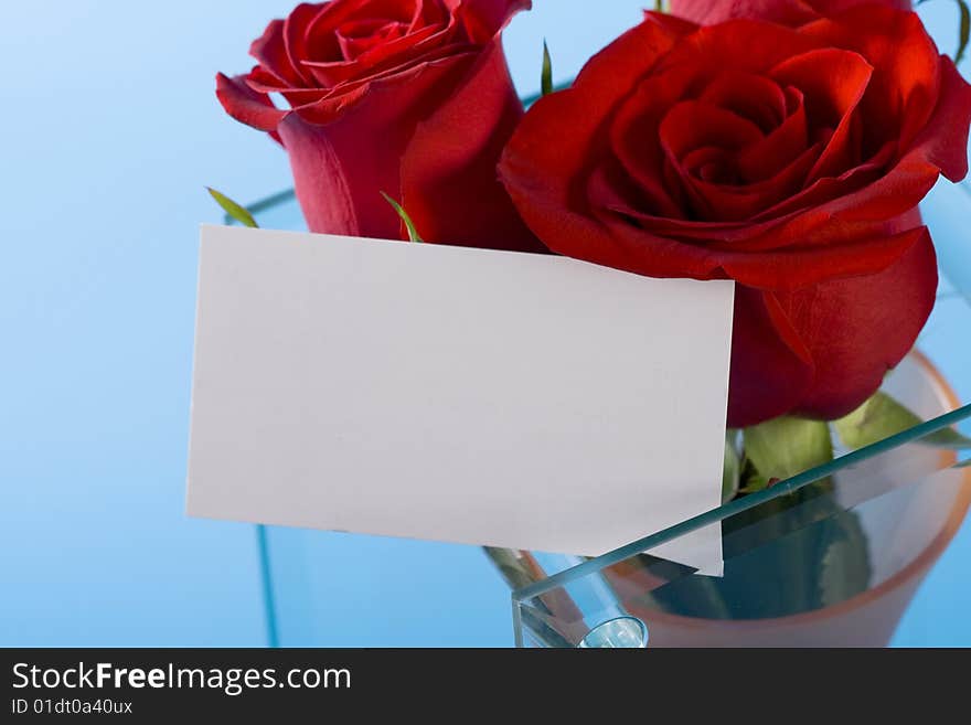 Red roses in the vase and note on it. Red roses in the vase and note on it