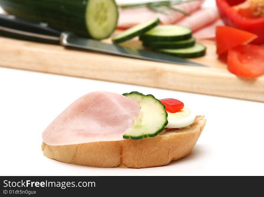 Ham,cucumber,egg and bread on white. Ham,cucumber,egg and bread on white