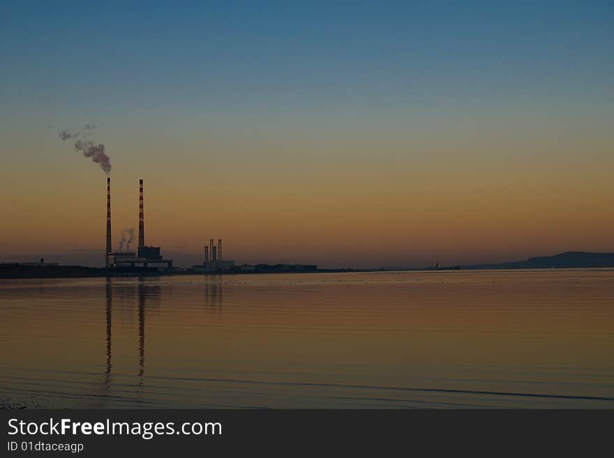 Smoking pipes from power station in Dublin during sunset