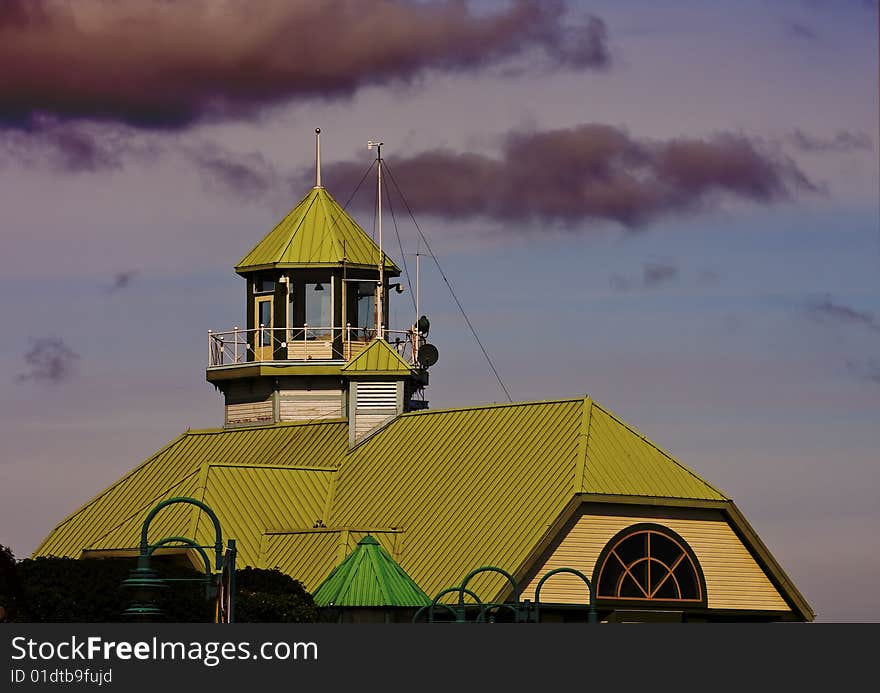 A bright green roof against a dark stormy sky. A bright green roof against a dark stormy sky