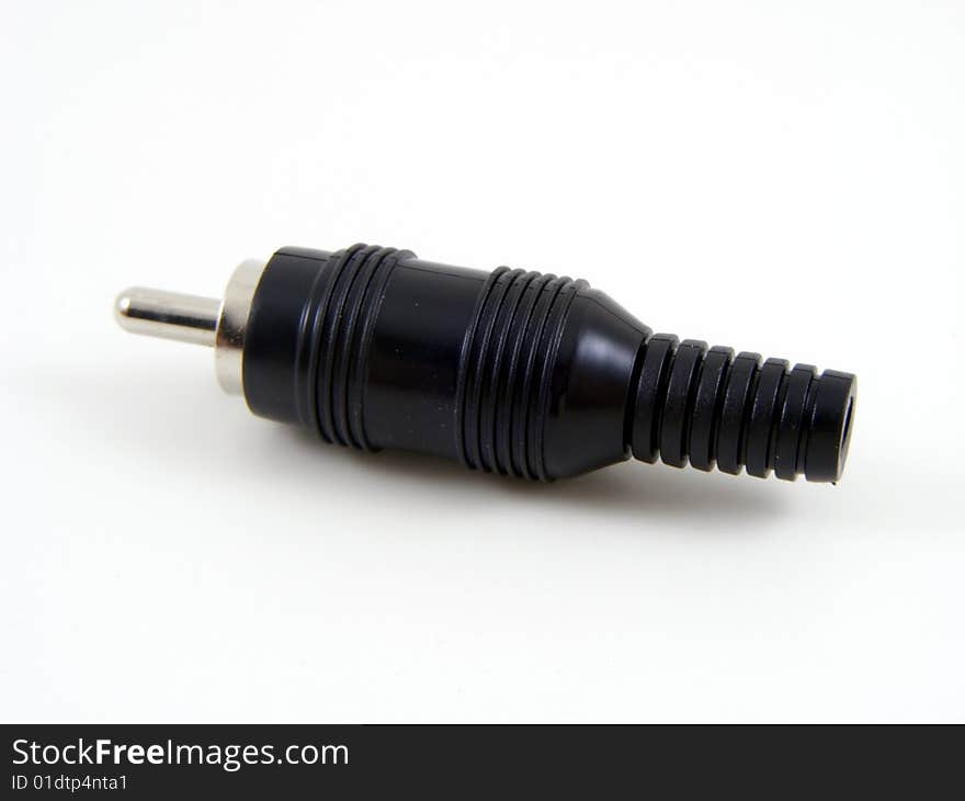 Black phono (RCA Jack) type plug on a plain background. Black phono (RCA Jack) type plug on a plain background