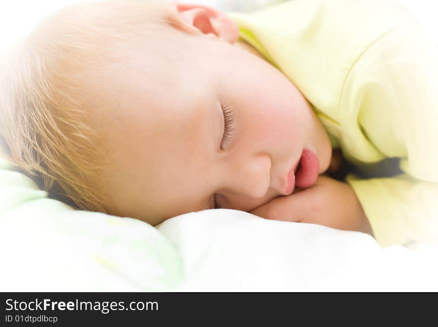 Restful two years baby boy sleeping on bed. Restful two years baby boy sleeping on bed