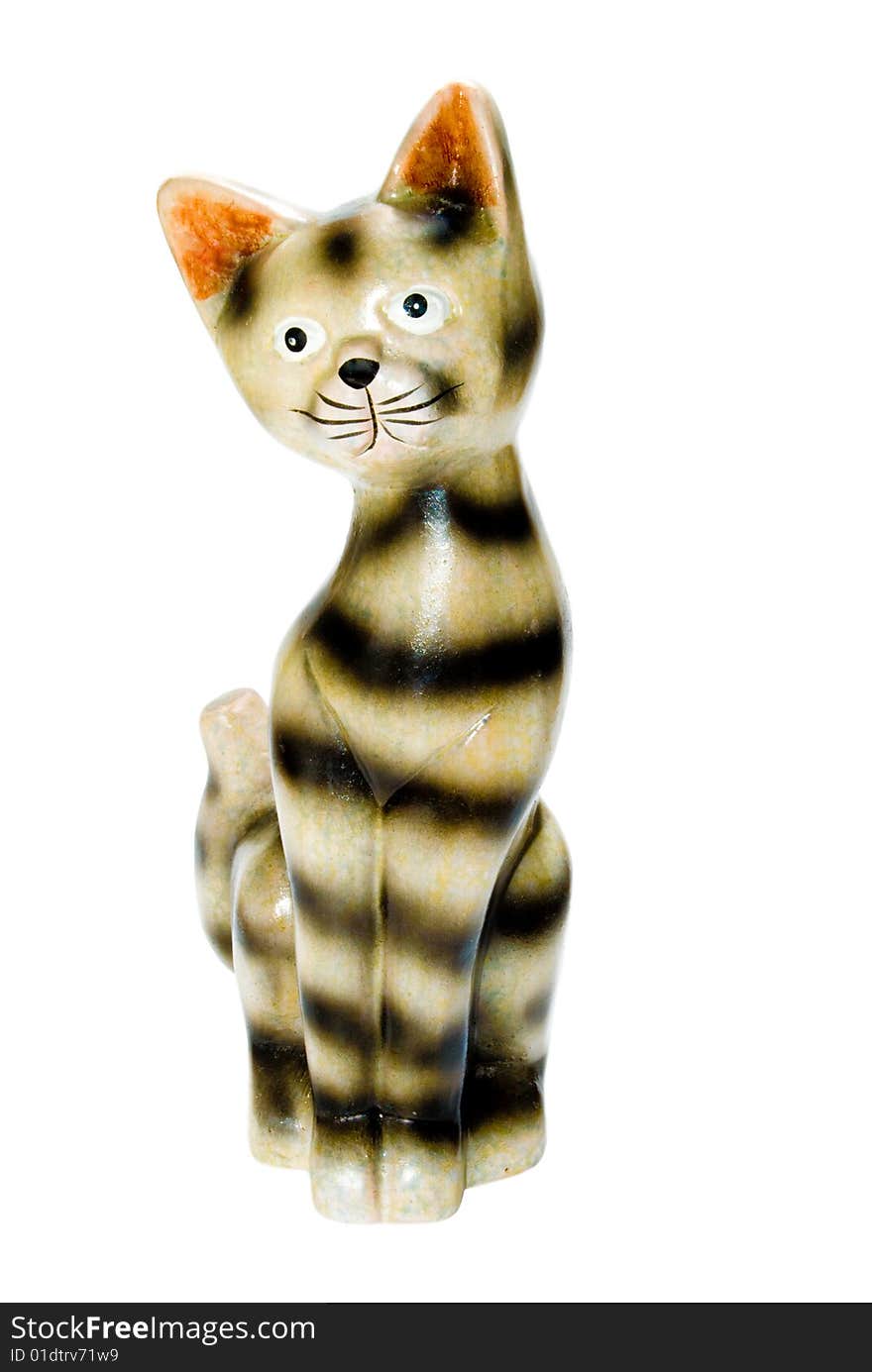 A ceramic statue of a black and off-white or yellow cat with orange-red ears isolated on a white background. A ceramic statue of a black and off-white or yellow cat with orange-red ears isolated on a white background.