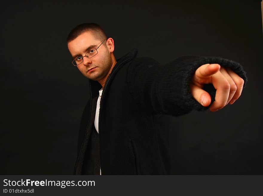 Young relaxed casual man pointing with his finger