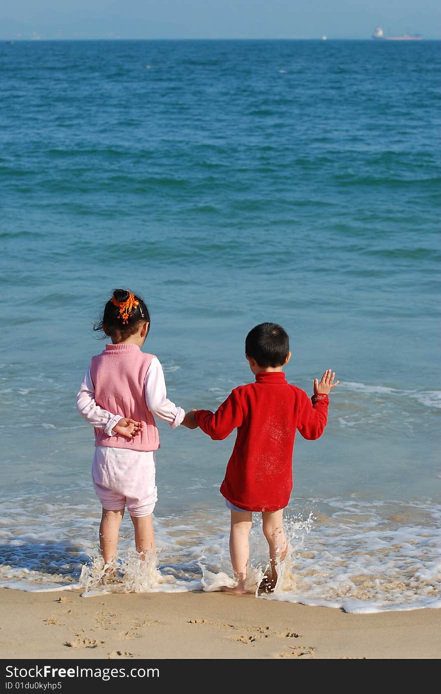 Young Kids Playing in the surfy beach