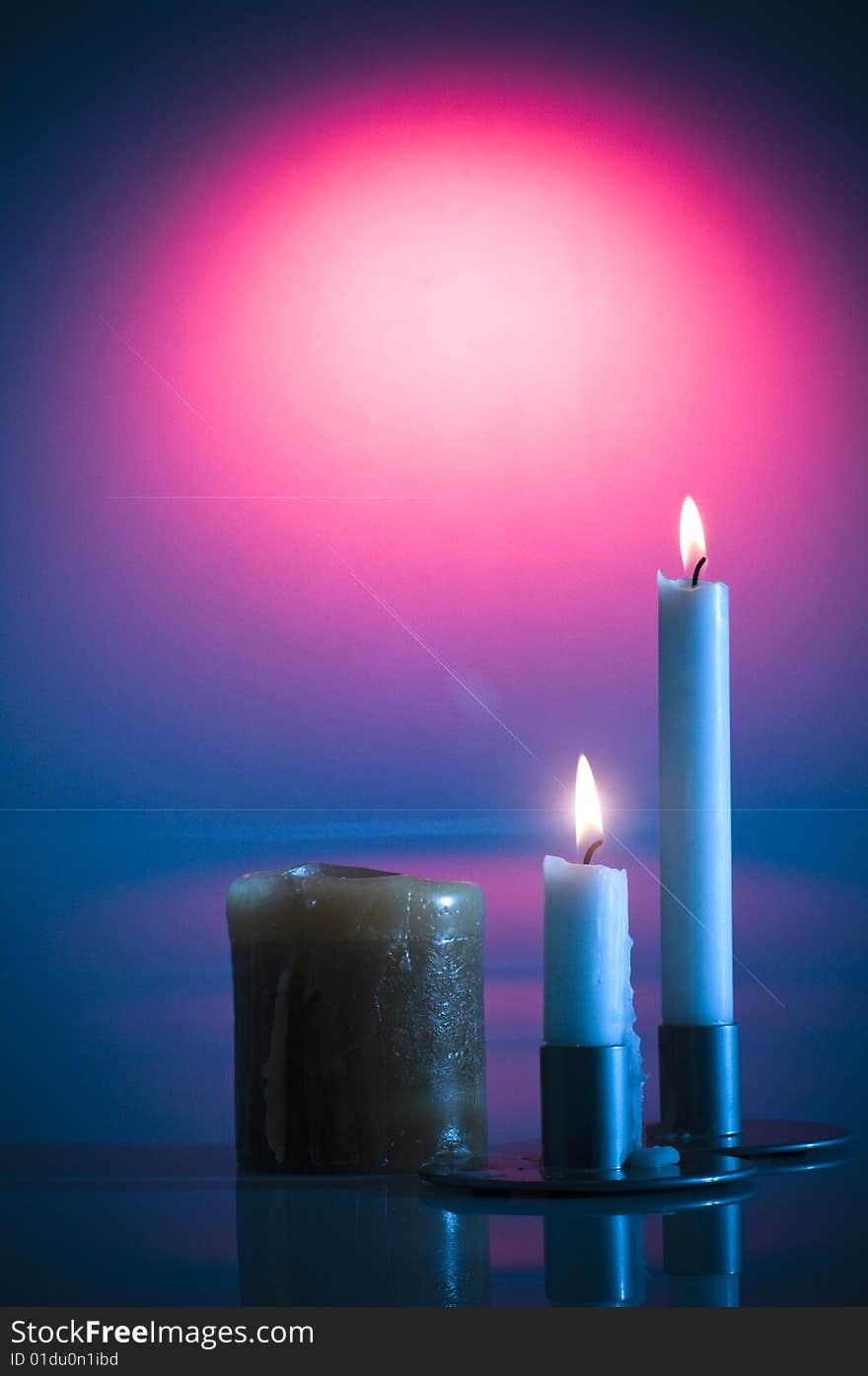 Valentine's burning candles in blue and red colours.