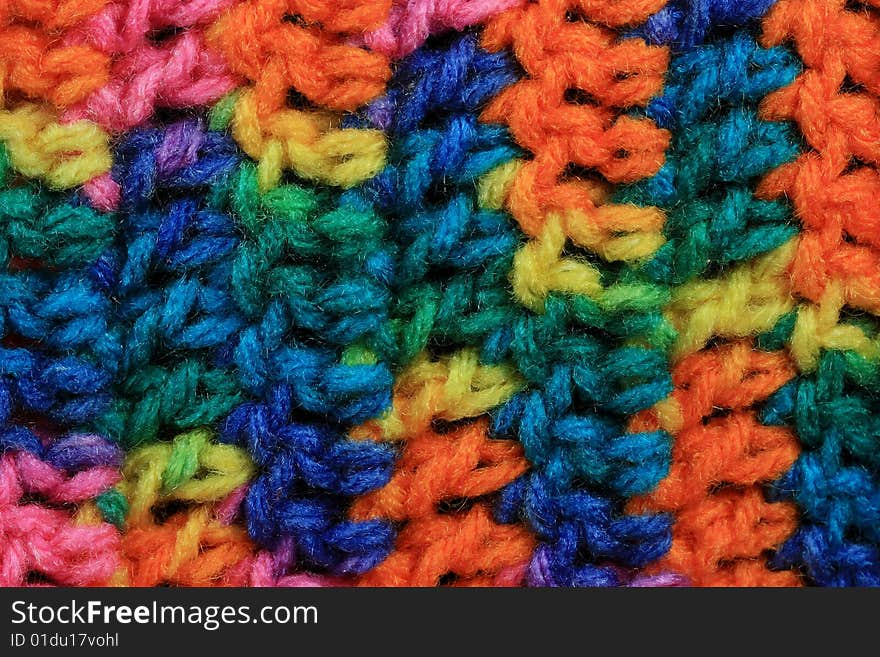 Textured brightly colored stitches of crochet background.