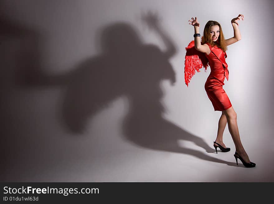 Young girl in red dress with wings. Young girl in red dress with wings