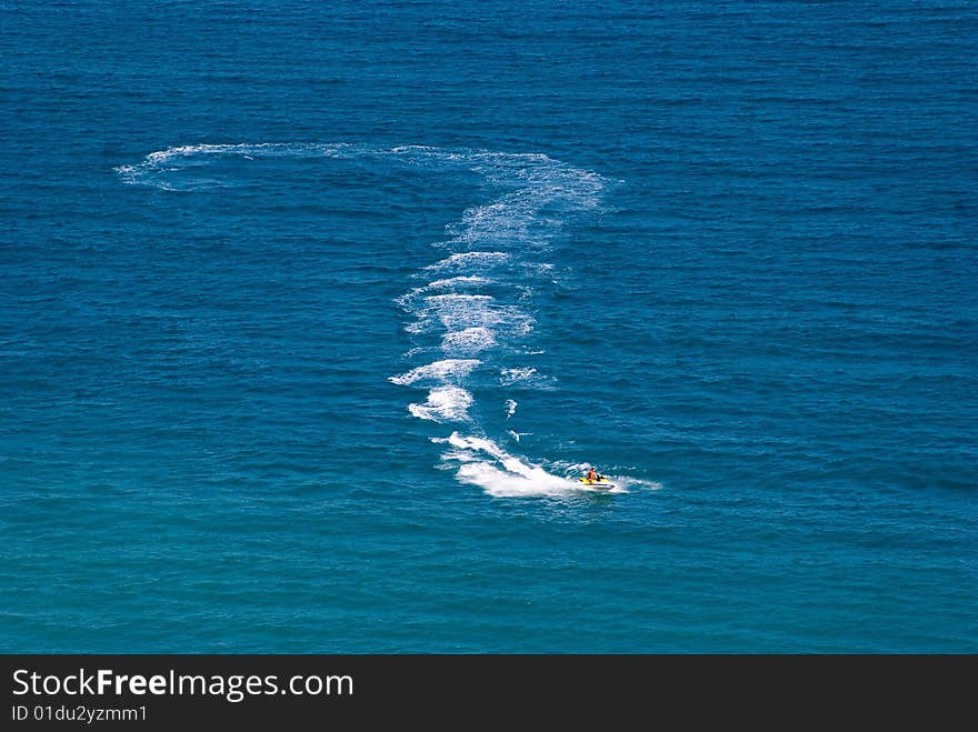 Question mark on water drawn by a jetski