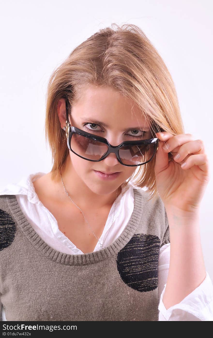 Young lady taking off her sunglasses. Young lady taking off her sunglasses